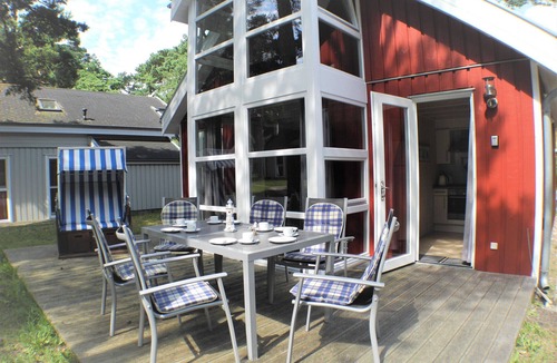 Gohren House | Child-friendly vacation home Ostseeblick 205 in Baabe. Cozy patio with a beach chair, patio furniture, and an outdoor grill. A spa with a whirlpool and sauna for a relaxing vacation
