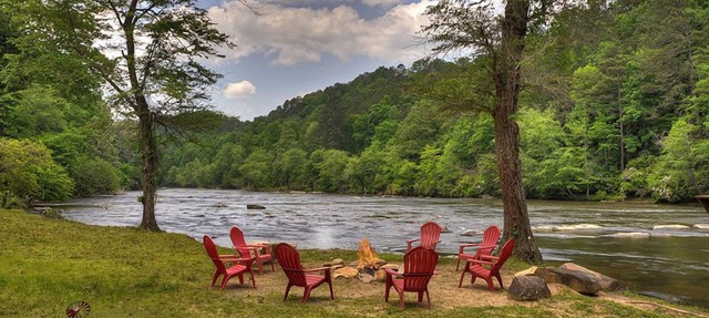 Hunter's Lodge, a pet-friendly riverfront cabin, complete with a pool table, lit basketball court, fire pit, dock, and WiFi in Ellijay